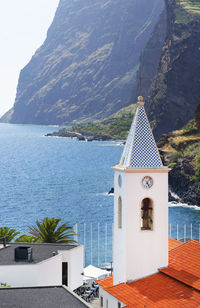 High angle view of church by sea against mountain