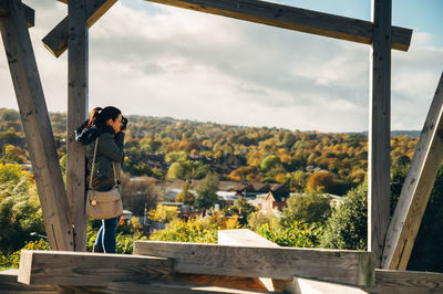 Woman standing on landscape against sky