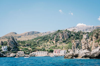 Scenic view of sea and mountains against sky