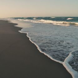 Scenic view of beach against sky during sunset