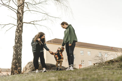 Women with daughter having walk