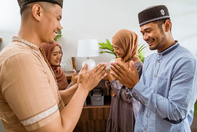 Side view of couple holding hands