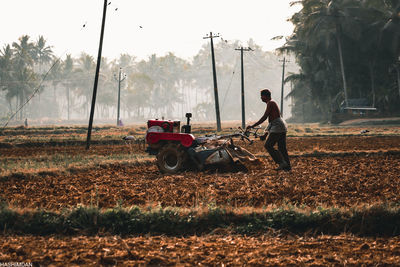 Man and tractor on field