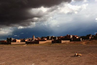 Buildings against cloudy sky