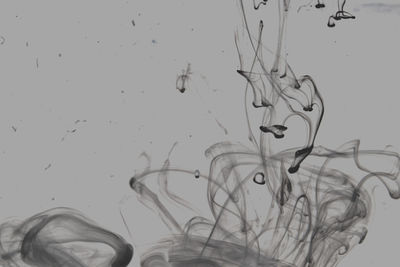 Close-up of ink underwater against gray background