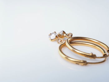 Close-up of wedding rings on metal against white background