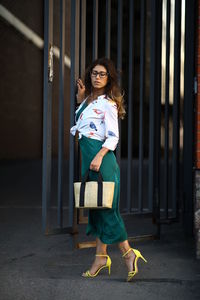 Full length of woman standing on land by gate