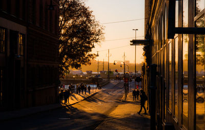 Group of people in city at sunset