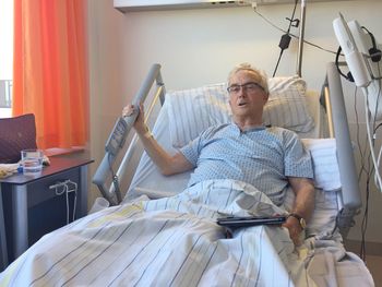 Portrait of mature patient lying on bed at hospital