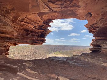 View of natures window formation against cloudy sky