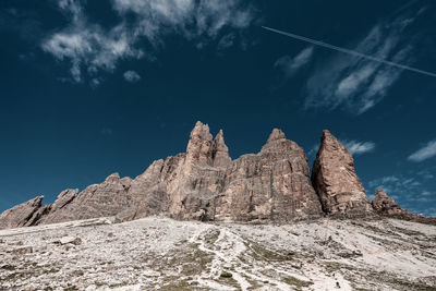 Low angle view of rock formation against sky