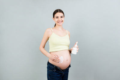 Portrait of a smiling young woman over white background