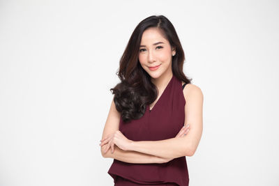 Portrait of a smiling young woman over white background