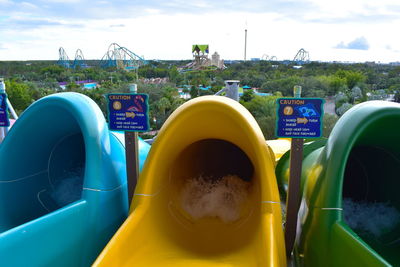 Close-up of yellow playground against swimming pool