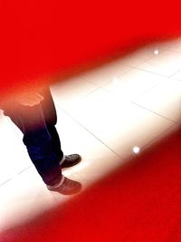 Low section of woman standing on tiled floor