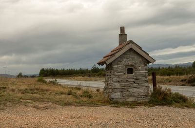 Abandoned built structure on field against sky