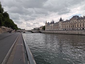 View of bridge over river against cloudy sky