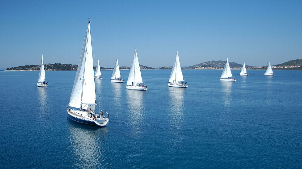 nautical vessel, transportation, boat, mode of transport, water, waterfront, clear sky, sea, sailboat, copy space, blue, travel, moored, sailing, mast, tranquility, nature, tranquil scene, day, outdoors