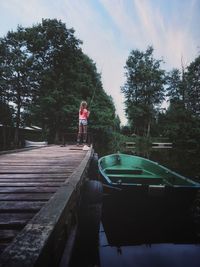 Rear view of girl fishing in lake