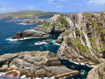 Rock formations by sea against sky