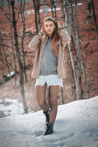 Full length of woman standing in snow