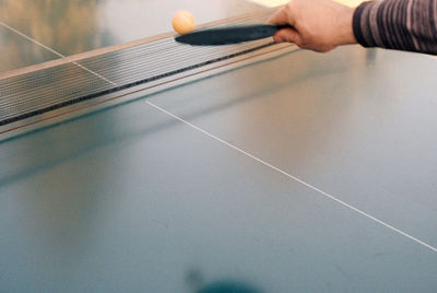 Cropped hand playing table tennis