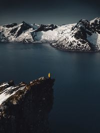 Scenic view of lake and snowcapped mountain against clear sky