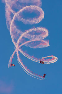 Low angle view of airplane flying against sky