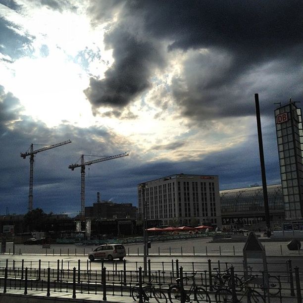 sky, cloud - sky, crane - construction machinery, cloudy, transportation, mode of transport, built structure, building exterior, street light, architecture, weather, development, harbor, construction site, cloud, industry, city, no people, overcast, outdoors