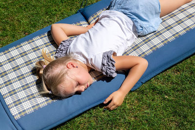 High angle view of boy relaxing on field