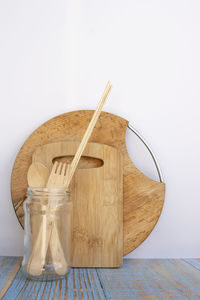 Close-up of glass jar on table against white background