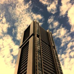 Low angle view of buildings against cloudy sky
