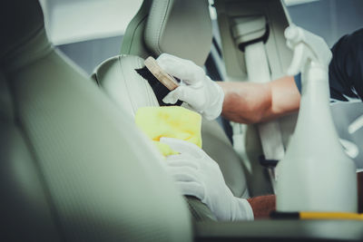 Cropped hand of doctor examining patient in car