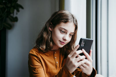 Portrait of teenage girl using mobile phone