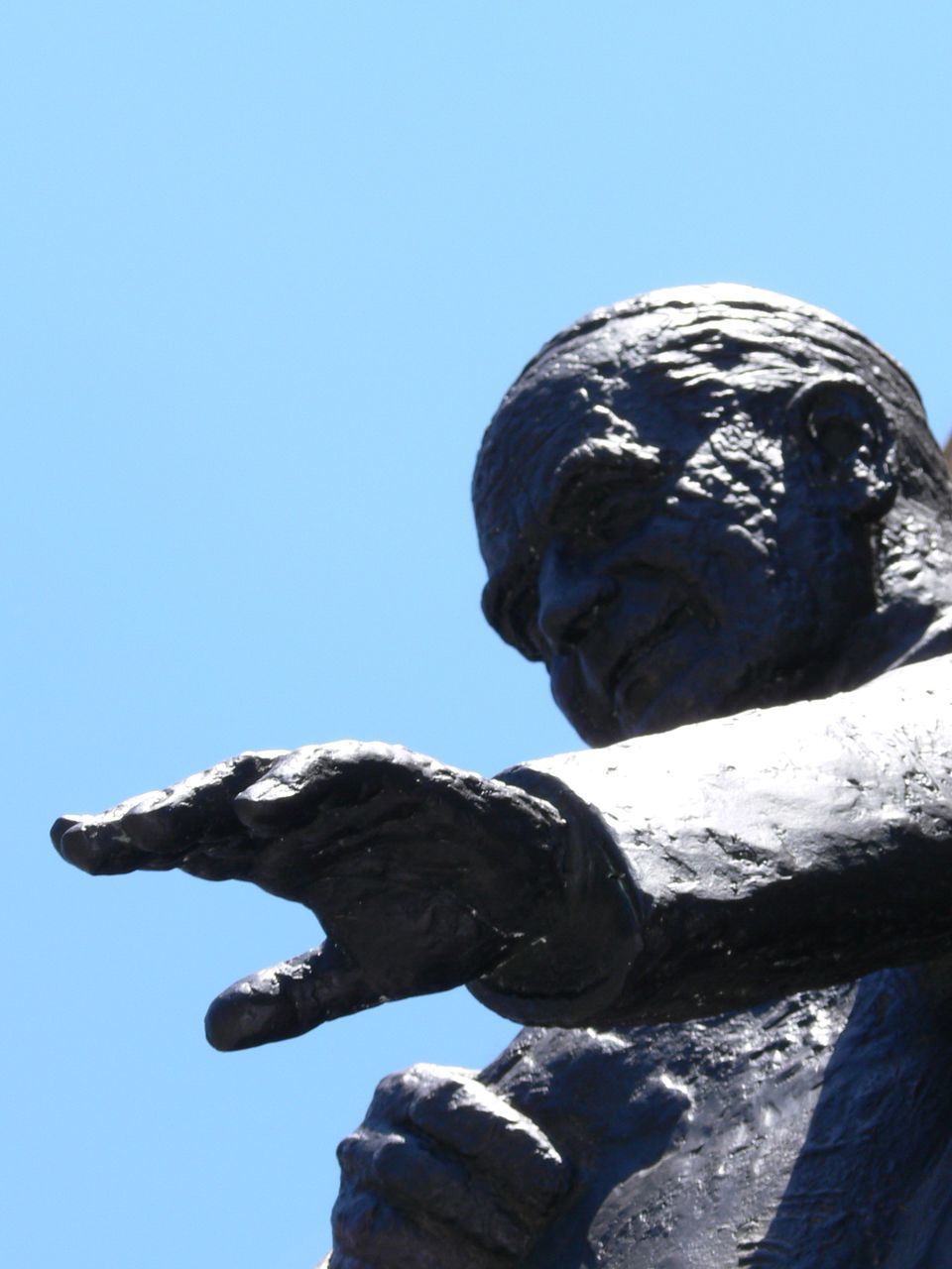 CLOSE-UP OF STATUE AGAINST BLUE SKY