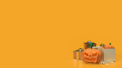 Close-up of small toy against orange wall