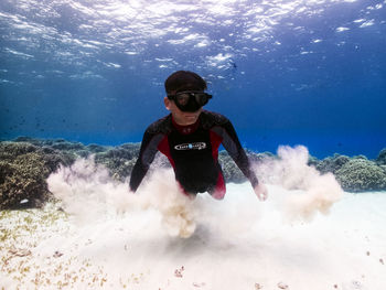 Young man swimming in sea