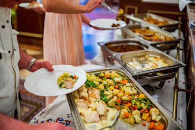 Midsection of woman holding food