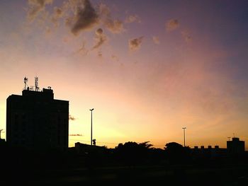 Low angle view of silhouette building against sky at sunset