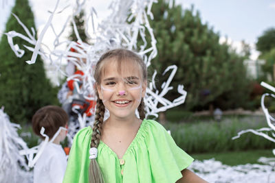 Portrait of smiling girl standing outdoors