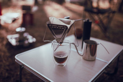 Close up photo of man preparing coffee at camping in forest.