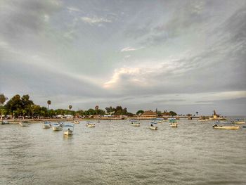 Sailboats in sea against sky