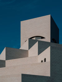 Low angle view of building against clear blue sky