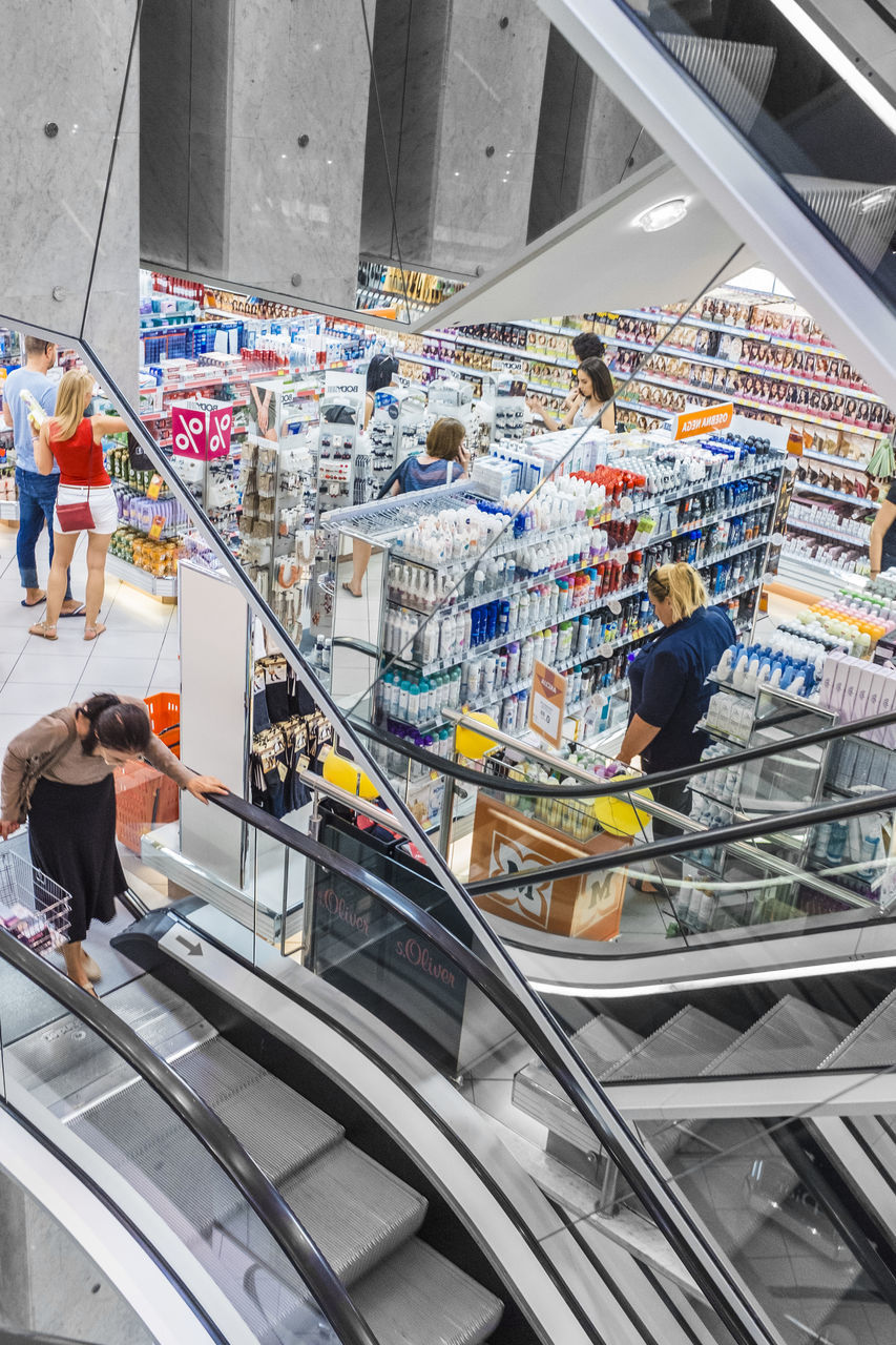 HIGH ANGLE VIEW OF PEOPLE WALKING ON STAIRCASE