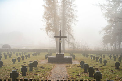 View of cemetery against foggy weather