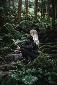 Side view of woman in forest