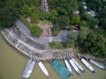 High angle view of swimming pool by river against buildings