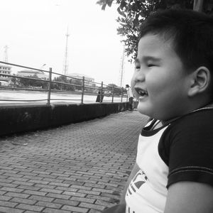 Portrait of boy looking away against sky