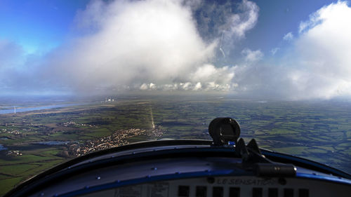 Airplane flying over water against sky