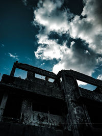 Low angle view of abandoned building against sky